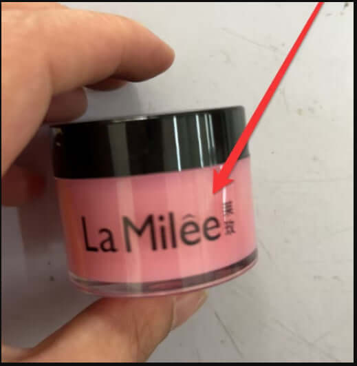 Close-up of La Milée moisturizing lip care cream in a pink container, showcasing stylish design and hydration benefits.